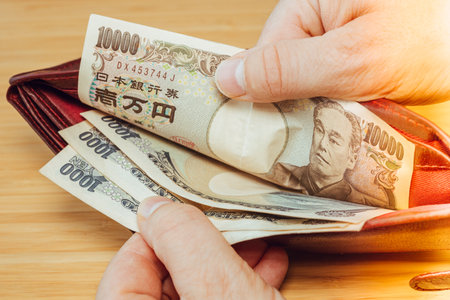 Japan money. Hand taking money out of wallet. Japanese yen, financial concept