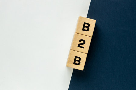 B2B business to business symbol on wooden blocks with navy blue and white background. Cooperation icon. Business transaction and corporate partnership concept, copy spaceの写真素材