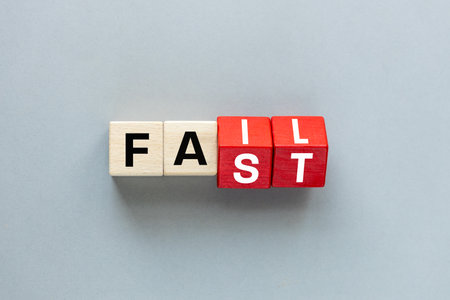 FAIL and FAST concept. letters on wooden blocks changing the word fast to fail, concept, beautiful gray background. flat lay, copy spaceの写真素材