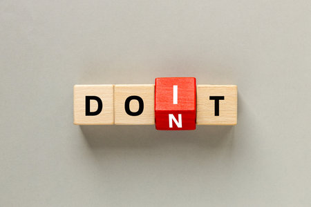 Don't do and do it. Conceptual words, don't do changing do it. Text on wooden blocks. Beautiful Gray background. copy space. flat layの写真素材