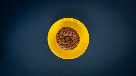 delicious chocolate donut on a yellow plate on a navy blue background