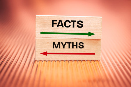 Facts vs. Myths. Concept, Reliability and Disinformation, Information against Fake News. Written on wooden blocks, fiery background, close upの写真素材