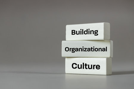A white wooden block with the words Building, Organizational, Culture, Modern approach to working...