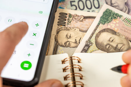 Japanese Yen, Counting on smartphone calculator, JPY money, notes in notebook. Financial settlement, Household budget, Taxes, Japan currency exchange rate, Business Financial Analysis Conceptの写真素材