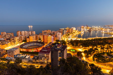 MÃ¡laga night view. A wonderful urban landscape of the city of Malaga in Spain. View after sunset, City panorama with bullfighting arenaの写真素材