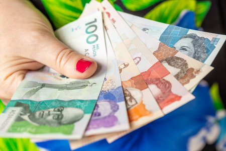 Colombia money. A woman is holding Colombian pesos in her hand. Financial and business conceptの写真素材
