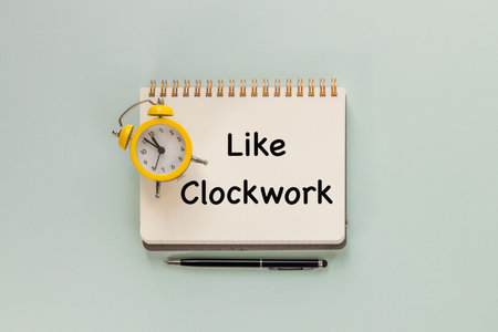 Slogan like a clock in a notebook and an alarm clock. Conceptual words. Punctuality, deadlines, copy...