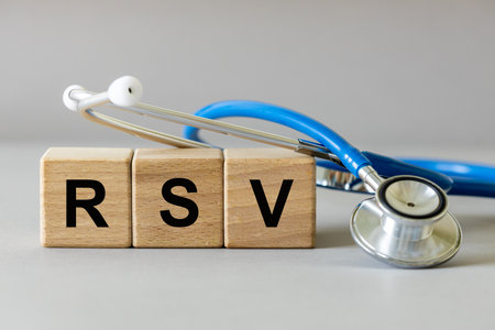RSV viruses. Flu season. Medical concept. RSV written on wooden blocks and a lying stethoscope. Copy space. close upの写真素材