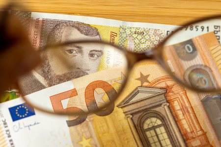 Bulgaria's entry into the Eurozone. Conversion of the Bulgarian lev to the euro. Financial and business concept. Analysis of currency change in Bulgaria. View of money through glassesの写真素材