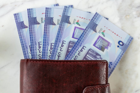 United Arab Emirates money. UAE, dirham banknotes sticking out of wallet. Currency AED. Business and...