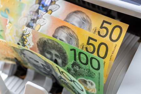 Australia money. Counting Australian dollars in a money counter. Financial and business concept....
