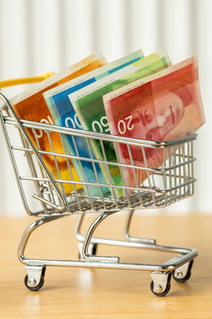 Money. A shopping cart with currency. Financial and economic concepts. Growing cost of living. More expensive goods and services. close upの写真素材