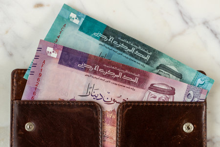 Jordan currency. Jordanian dinars, 50 and 20 banknotes sticking out of the wallet. Currency JOD....
