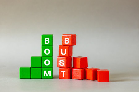 Boom and bust chart. Conceptual words, Business idea, Financial market, stock market trading, market speculation, profit and loss, Bull and bear market symbol on wooden blocks, gray background, copy spaceの写真素材