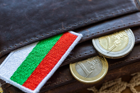 Euro coins falling out of a wallet with the Bulgarian flag. A financial and business concept. Bulgaria entry into the Eurozone. Close upの写真素材