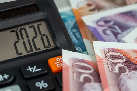 United Kingdom money. Finance 2026. Business and economic concepts. Symbol of the British pound. The year 2026 displayed on a calculator. Financial background. Close upの写真素材