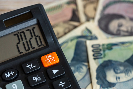 Japan money. Japanese yen and a calculator with the year 2026. Financial and economic concept. close up Business backgroundの写真素材