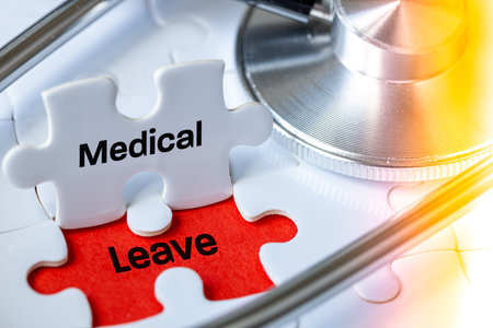 Medical leave. The concept of health. The phrase "Medical leave" is written on the jigsaw pieces next to a stethoscope. Breaks from work, illness, treatment. close upの写真素材