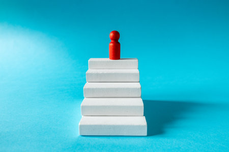 Achieving success. Stages of development. The leader of the organization at the top. White stairs...