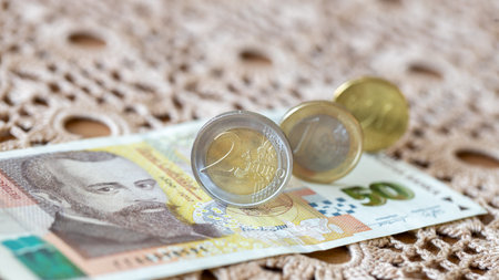 Eurozone Bulgaria, Financial and economic concept. Euro coins and a 50 Bulgarian lev note lying on a...