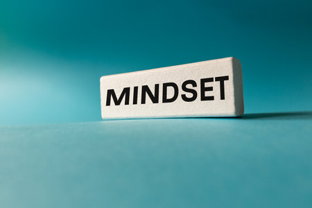 The Mindset concept. A new way of thinking. Perception of the environment and the world. Approach to challenges. Decision-making. Motivation to act. Copy space. Slogan written on white blocks, Blue backgroundの写真素材