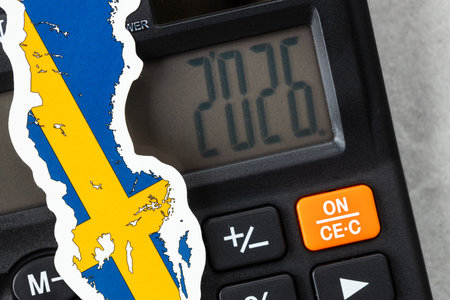 Sweden, 2026. Economic business concept. Swedish symbol on a calculator with the date 2026. Financial background. Close upの写真素材