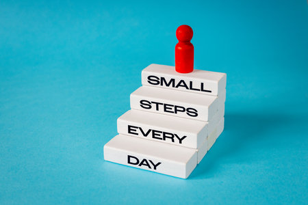 Small steps every day. Motivational slogan. Working on oneself. Conceptual words, Business symbol....