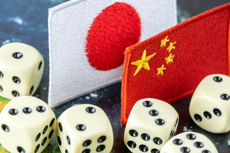 Dice, flags of Japan and China. Business and financial concept. Economic backgroundの写真素材