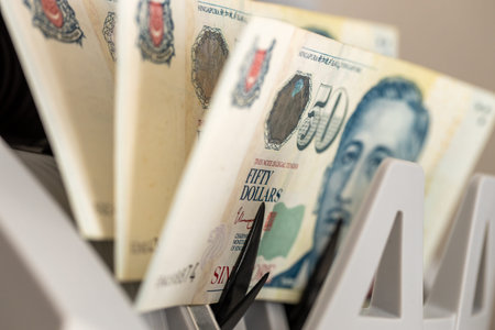 Singapore money. Dollars converted by machine. Business and financial concept. Close up