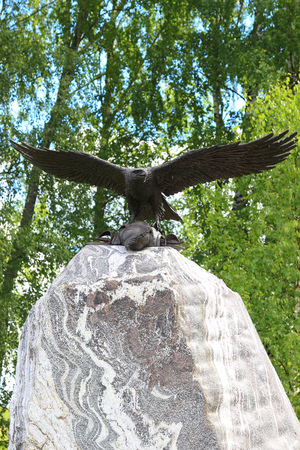 A bronze eagle taking off a stone monument with cuirass of a dead soldier. Russia, Borodino.のeditorial素材
