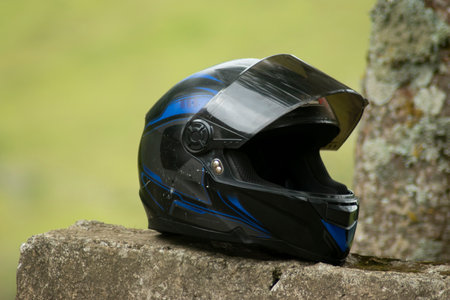 Mountain bike helmet lying on a stone, closeup of photoの写真素材