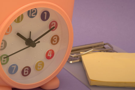 alarm clock and sticky note on purple background, time management conceptの写真素材