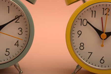 Close up of alarm clock on pink background with copy space for text.のeditorial素材