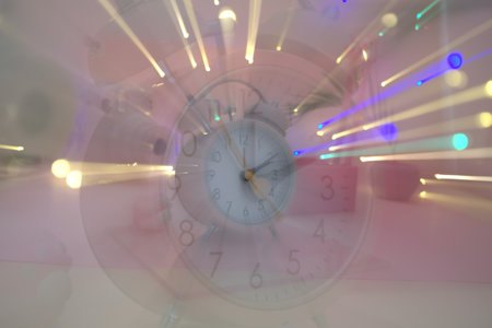 Retro clock with colorful lights in the background. Abstract blurred background.のeditorial素材