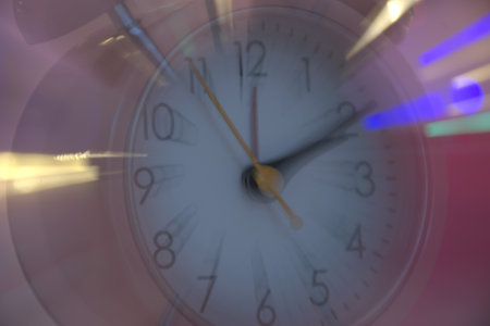 Close up of a clock face with bokeh effect. Abstract background.
