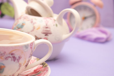 Cup of tea and teapot on purple background, close upの写真素材