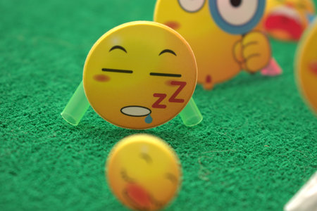 Funny smiley face on green grass background, closeup of photo