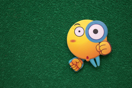 Funny face made of plasticine on green background with copy spaceの写真素材