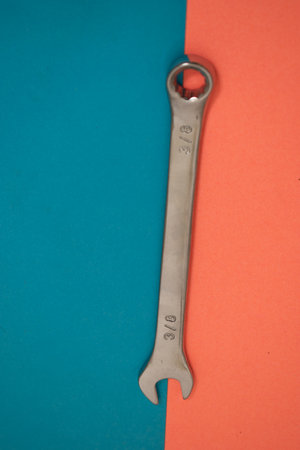 Spanner on a blue and red background. Top view.の写真素材