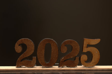 Figures of the year 2015 on a wooden table against a dark backgroundの写真素材