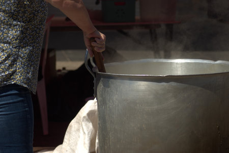 Making of traditional Turkish ice cream in a pot on the streetの写真素材