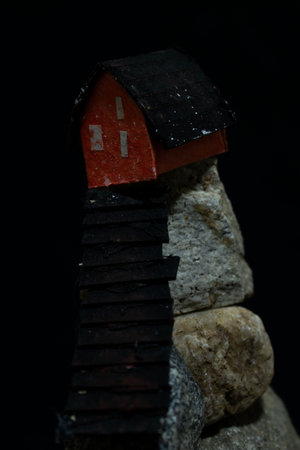 House made of stones on a black background. Conceptual image.の写真素材