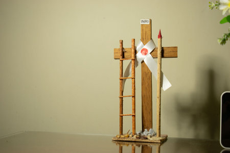 Wooden Christian cross with red cross on the table in a churchの写真素材