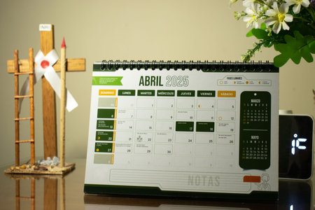 Calendar on the table with a cross and flower in the backgroundの写真素材