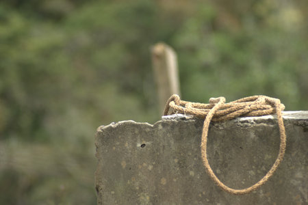 rope tied on the concrete wall, closeup of photo.の写真素材