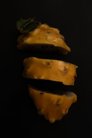 Prickly pear fruits on a black background, close-up