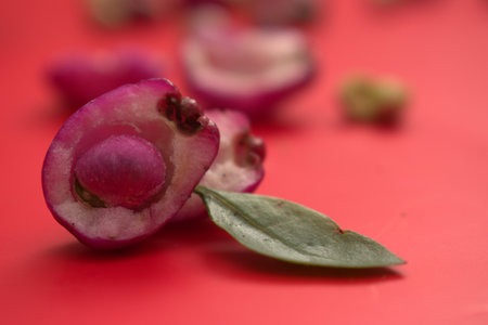 Fruit with leaves on a red background, close up