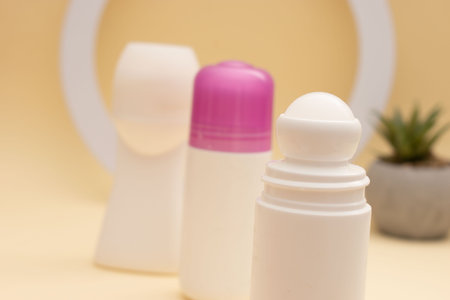 deodorant in white plastic bottle on yellow background with copy spaceの写真素材
