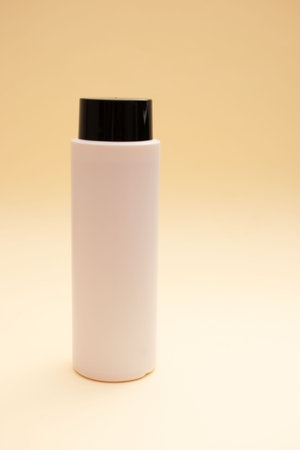 Blank white cosmetic bottle on beige background with copy space.の写真素材