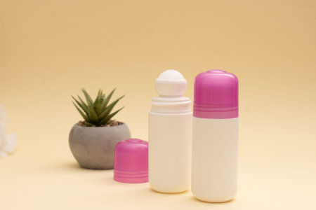 Set of deodorant and cream on a beige background.の写真素材